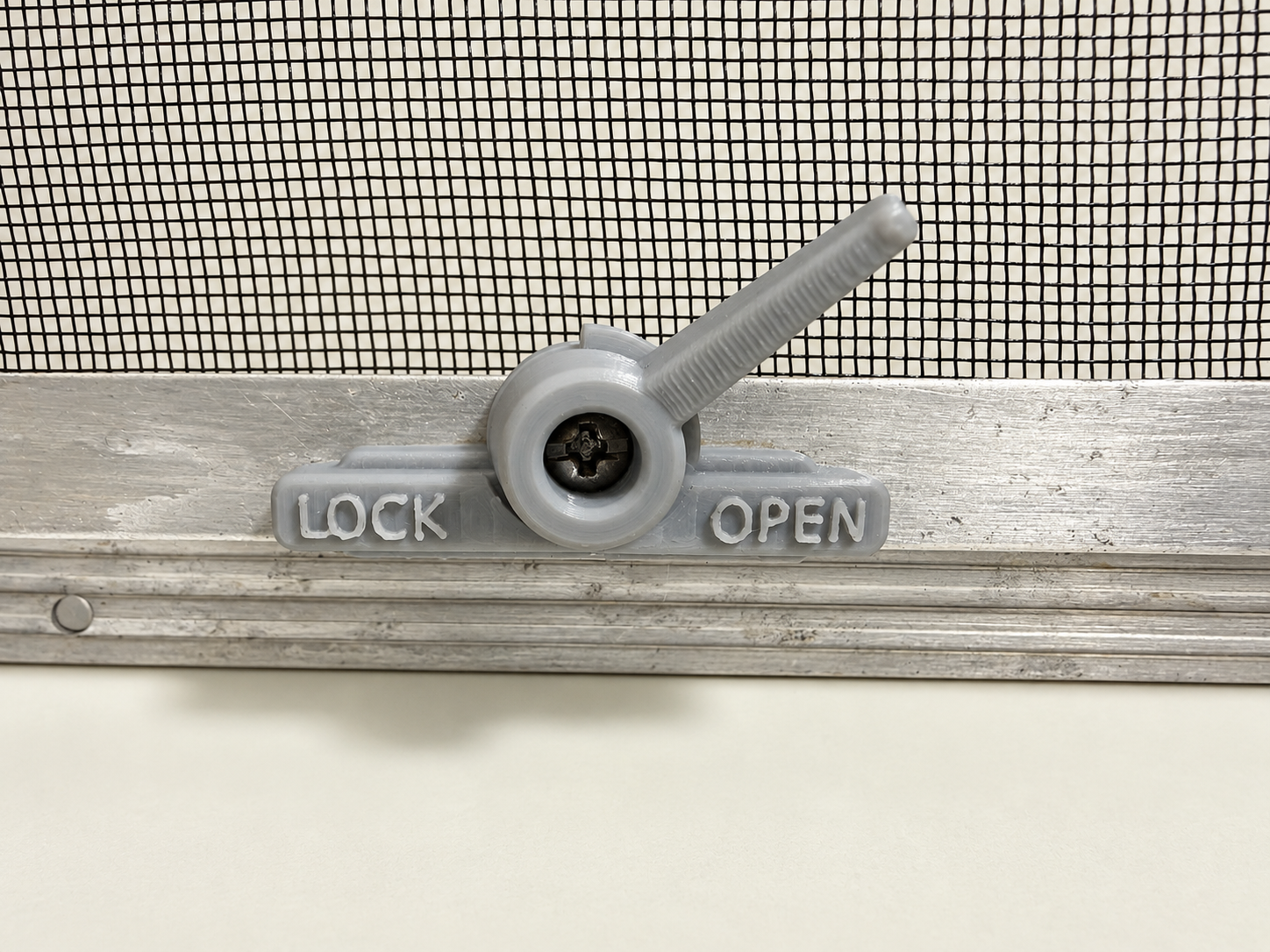 Light-grey replacement latch installed on a matching caravan window frame.